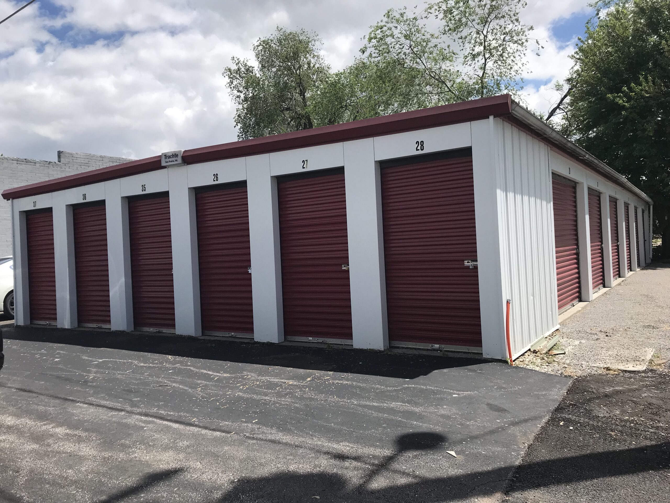 Numbered drive-up storage units with red doors